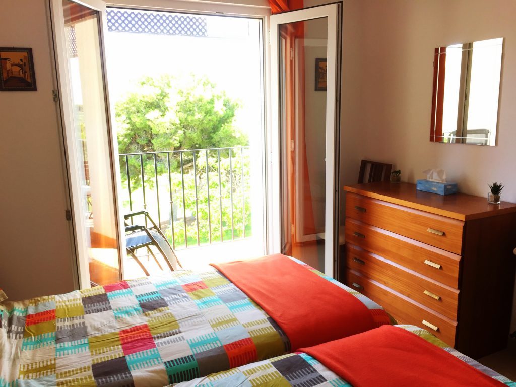 Bedroom 1 looking out to the balcony 